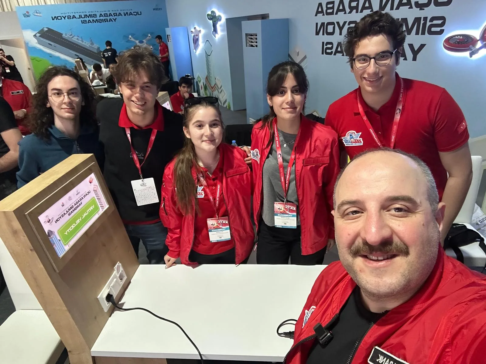 Team photograph at the TEKNOFEST Flying Car Simulation competition stand
