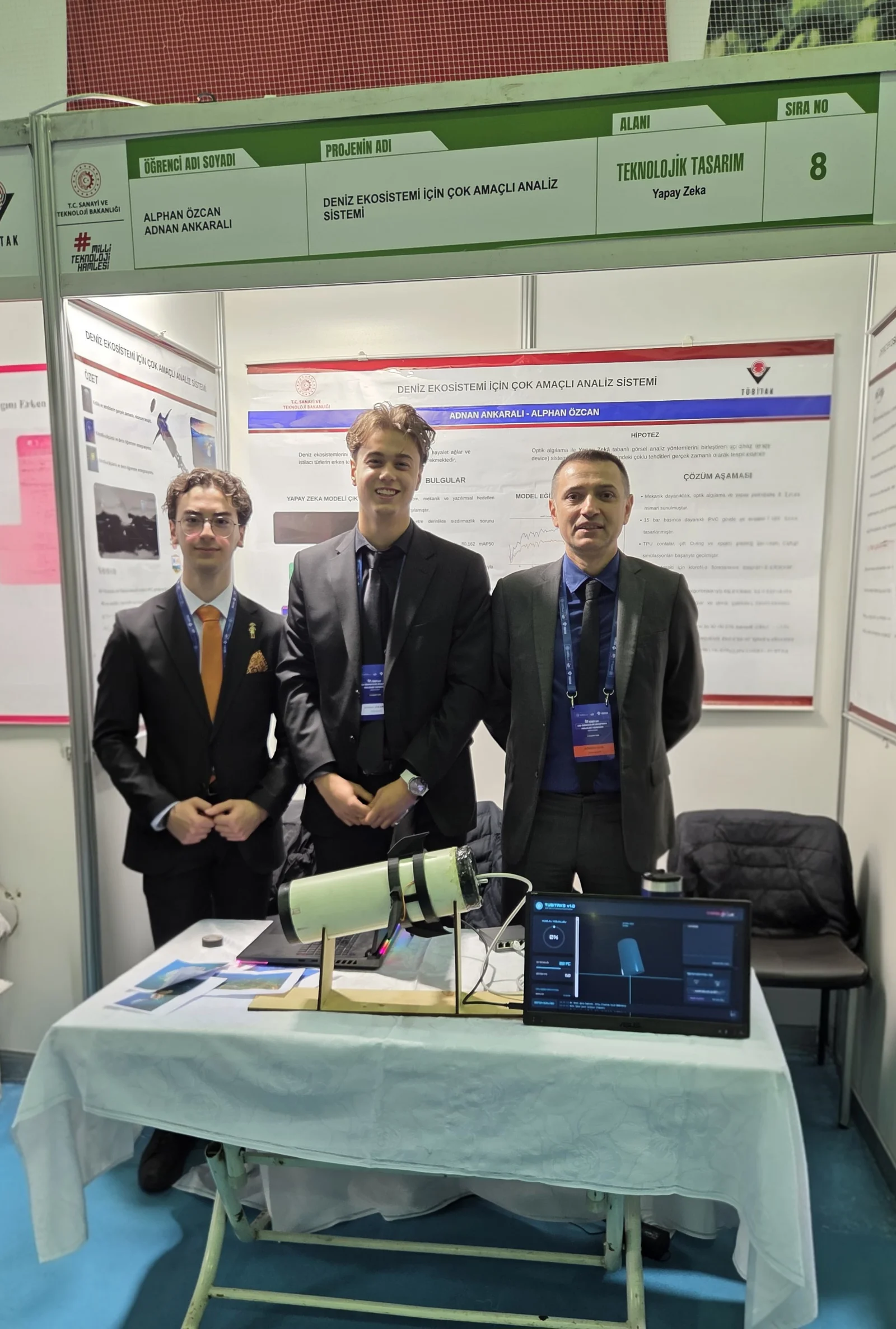 Marine Ecosystem project team with their underwater monitoring device, laptop and exhibition posters at TÜBİTAK